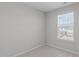 Carpeted bedroom with natural light from single window, neutral walls and trim at 5210 Blue Lagoon Ln, Raleigh, NC 27610