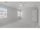 Carpeted bedroom features neutral walls, ceiling fan and two windows for natural light at 5210 Blue Lagoon Ln, Raleigh, NC 27610