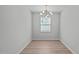 This dining room has a unique light fixture and large window at 5210 Blue Lagoon Ln, Raleigh, NC 27610