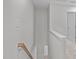 Hallway with wooden staircase and white railing leading to upper and lower levels at 5210 Blue Lagoon Ln, Raleigh, NC 27610