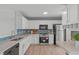 White cabinet kitchen with stainless appliances and a breakfast nook at 5210 Blue Lagoon Ln, Raleigh, NC 27610