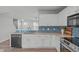 Kitchen with white cabinets, stainless steel appliances, and breakfast bar at 5210 Blue Lagoon Ln, Raleigh, NC 27610