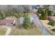 An aerial view showcases a home surrounded by lush greenery and mature trees, providing a private setting at 603 W Main St, Haw River, NC 27258