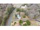An aerial view showcases the location of the home, road, and nearby treeline at 603 W Main St, Haw River, NC 27258