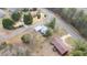 An aerial shot highlights the house near the road with trees and other houses nearby at 603 W Main St, Haw River, NC 27258