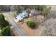 An aerial view shows a well-maintained property with a metal roof, mature trees, and established landscaping at 603 W Main St, Haw River, NC 27258