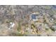 An aerial view highlighting a large lot adjacent to a neighborhood, forest, and commercial buildings at 603 W Main St, Haw River, NC 27258