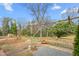 A backyard shows a patio trellis with string lights and flower beds in a well-maintained yard at 603 W Main St, Haw River, NC 27258