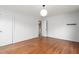Spacious bedroom with hardwood floors, a modern light fixture, and an open doorway to the next room at 603 W Main St, Haw River, NC 27258