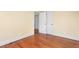 Bedroom showcasing hardwood floors, neutral walls, and a closet door, enhancing the room's clean aesthetic at 603 W Main St, Haw River, NC 27258
