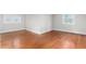 Bright empty bedroom with hardwood floors and windows, offering an ideal blank canvas for personalization at 603 W Main St, Haw River, NC 27258