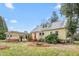 The exterior of the home shows a colorful door and trellis in the yard with beautiful landscaping at 603 W Main St, Haw River, NC 27258