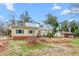 Charming yellow home with metal roof and red front door at 603 W Main St, Haw River, NC 27258