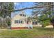 Charming yellow home featuring a red door, brick foundation, and a well-maintained front lawn at 603 W Main St, Haw River, NC 27258