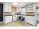 Bright kitchen featuring white cabinetry, a window over the sink, and unique patterned flooring at 603 W Main St, Haw River, NC 27258