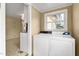 Functional laundry area with a window and a washer-dryer setup, conveniently located off the kitchen at 603 W Main St, Haw River, NC 27258