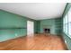 Spacious living room with a fireplace, built-in bookshelves, hardwood floors, and ample natural light at 603 W Main St, Haw River, NC 27258