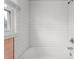 White tiled shower and tub combo with window at 603 W Main St, Haw River, NC 27258