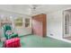 Bright sunroom with white ceiling, brick accent wall and many windows at 603 W Main St, Haw River, NC 27258