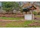 Charming backyard with well, brick features, mature trees and greenery create a serene outdoor space at 605 Canterbury Rd, Sanford, NC 27330