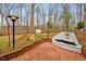 A charming backyard featuring brick pathway, white fountain and storage building at 605 Canterbury Rd, Sanford, NC 27330