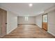 Spacious basement with light-colored walls and wood flooring. Two entry doors are visible at 605 Canterbury Rd, Sanford, NC 27330