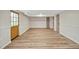 Unfurnished basement featuring wood flooring, a door to the exterior, and neutral walls at 605 Canterbury Rd, Sanford, NC 27330
