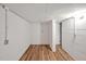 Unfinished basement with concrete block walls, exposed wiring, and wood flooring at 605 Canterbury Rd, Sanford, NC 27330
