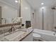 Updated bathroom featuring a granite vanity, large mirror, and tiled shower with tub at 605 Canterbury Rd, Sanford, NC 27330