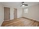 This bedroom features light wood floors, neutral walls, two doors and a window for natural light at 605 Canterbury Rd, Sanford, NC 27330