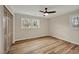Empty bedroom features neutral walls, wood-look floors, closet and a window at 605 Canterbury Rd, Sanford, NC 27330