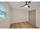 This cozy bedroom features neutral walls, wood floors, ceiling fan and natural light from a large window at 605 Canterbury Rd, Sanford, NC 27330