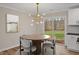 Stylish dining area features modern lighting, a round table, and sliding glass doors, perfect for entertaining at 605 Canterbury Rd, Sanford, NC 27330