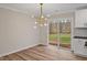 Bright dining area with modern lighting, hardwood floors, and sliding glass doors, creating an inviting atmosphere at 605 Canterbury Rd, Sanford, NC 27330