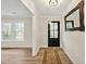 Inviting entryway featuring wood-look floors, large windows, and attractive wall decor at 605 Canterbury Rd, Sanford, NC 27330