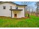 Exterior rear view of a charming home with a lush green lawn and black rain gutters at 605 Canterbury Rd, Sanford, NC 27330