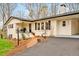 Stylish home showcasing a white exterior, dark roof, and a well-maintained walkway, offering a welcoming entrance at 605 Canterbury Rd, Sanford, NC 27330
