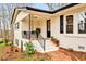 Inviting front porch featuring elegant railing, comfortable seating, and tasteful landscaping, enhancing curb appeal at 605 Canterbury Rd, Sanford, NC 27330