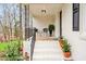 Cozy front porch with a stylish railing, comfortable seating, and charming potted plants, creating a welcoming entrance at 605 Canterbury Rd, Sanford, NC 27330