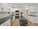 Well-equipped kitchen features white cabinets, stainless steel appliances, and modern countertops, perfect for cooking and entertaining at 605 Canterbury Rd, Sanford, NC 27330