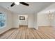 Open living room with a window and doorway views to other rooms of the home, and wood-look floors at 605 Canterbury Rd, Sanford, NC 27330