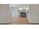 Open-concept living room with a dining room and a view of the renovated kitchen area and sliding glass doors at 605 Canterbury Rd, Sanford, NC 27330