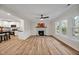 Sunlit living room features a fireplace, hardwood floors, and large windows, offering a warm and inviting space at 605 Canterbury Rd, Sanford, NC 27330