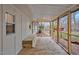 Relaxing screened in porch with wooden floors and built-in bench offers outdoor living space at 605 Canterbury Rd, Sanford, NC 27330