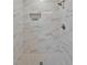 Beautiful marble tile shower featuring a niche, updated fixtures, and hexagon tile floor at 605 Canterbury Rd, Sanford, NC 27330