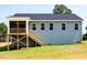 Two-story home with gray vinyl siding, white trim, a screened porch, a deck, and a backyard at 63 Tee Time Ter, Benson, NC 27504