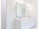 Bright bathroom with double sinks, granite countertops, white cabinets, and a large mirror at 63 Tee Time Ter, Benson, NC 27504