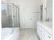 Luxurious bathroom showcasing a glass-enclosed shower, soaking tub, double vanity, and marble flooring at 63 Tee Time Ter, Benson, NC 27504