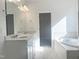 Bright bathroom featuring double vanity, a soaking tub with marble surround, and neutral walls at 63 Tee Time Ter, Benson, NC 27504