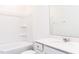 Bathroom with a combined bathtub and shower with white tiled walls, and a vanity with a white countertop at 63 Tee Time Ter, Benson, NC 27504